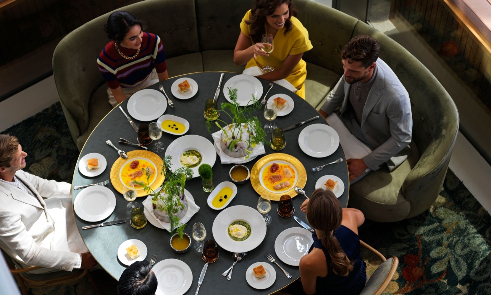 Customers dining at a'Mare around a large table
